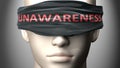 Unawareness can make things harder to see or makes us blind to the reality - pictured as word Unawareness on a blindfold to Royalty Free Stock Photo