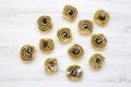 Unbaked cookies with poppy seeds, raisins. White wooden table, top view. From above, flat lay.