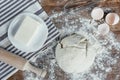 Unbaked dough with ingredients and rolling pin on table top