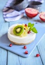 Unbaked mini cheesecakes topped with pineapple, kiwi and pomegranate Royalty Free Stock Photo