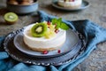 Unbaked mini cheesecakes topped with pineapple, kiwi and pomegranate Royalty Free Stock Photo