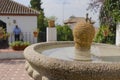 Unbalanced fountain and a man waiting