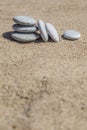 Unbalanced stones on sand Royalty Free Stock Photo