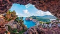 Unbelievable summer view of Caccia cape from the small cave in the cliff. Marvelous morning scene of Sardinia island, Italy, Europ