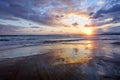 Unbelievable sunrise. Beautiful summertime view seascape. The wet sand on the sea coast. Morning landscape. High waves with foam. Royalty Free Stock Photo