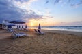 Unbelievable sunrise. Empty beach with umbrellas and deck chairs closed. Beautiful summertime view seascape. Morning landscape.