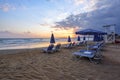 Unbelievable sunrise. Empty beach with umbrellas and deck chairs closed. Beautiful summertime view seascape. Morning landscape. Royalty Free Stock Photo