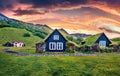 Unbelievable sunrise in icelandic countryside. Typical view of turf-top houses in Iceland