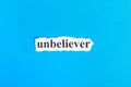 unbeliever text on paper. Word unbeliever on torn paper. Concept Image Royalty Free Stock Photo