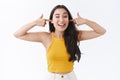 Unbothered, carefree pretty east-asian girl uninterested what are you talking about, acting silly, put fingers in ears Royalty Free Stock Photo