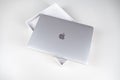 Unboxing a silver macbook air on a white table. Apple laptop Royalty Free Stock Photo