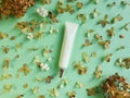 Unbranded face and eye cream squeeze cosmetic tube with long nozzle and bronze screw cap and dried hydrangea flowers on green