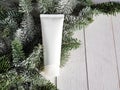 Unbranded white cosmetic products squeeze tube - cream, moisturizer, facial cleanser or shampoo on white wooden background with