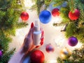 Unbranded white plastic spray bottle, female hand with red nails, christmas balls and fir tree on gray table. Natural organic spa Royalty Free Stock Photo