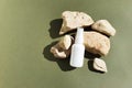 Unbranded white plastic spray bottle and stones on a dark green background.  Natural organic spa cosmetics and liquid Royalty Free Stock Photo