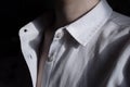 Unbuttoned shirt. Woman in a white shirt. Cotton shirt close up details. Neck and skin. Dark photo with shadows. Formal cloth. Wit