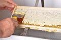 Uncapping of honeycomb at plastic tub Royalty Free Stock Photo