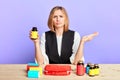 Uncertain woman with clueless expression in front of table with lots of pills