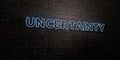 UNCERTAINTY -Realistic Neon Sign on Brick Wall background - 3D rendered royalty free stock image