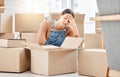 The uncertainty of what comes next is frightening to her. a young woman looking unhappy while moving house.