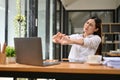 Uncomfortable Asian businesswoman stretching her arms, suffering from office syndrome Royalty Free Stock Photo