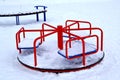 Children`s carousel on the snow-covered area