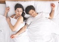 Young woman suffering from her sprawled man in bed Royalty Free Stock Photo