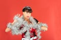 Uncomfortable woman wrapped in silver tinsel