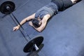 Unconcious Caucasian Man Faint on the Gym Floor with a Barbell in Front of Him