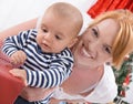 Unconditional love - mother and baby opening a Christmas or birthday present Royalty Free Stock Photo