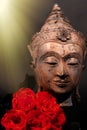 Unconditional love. Spiritual enlightenment. Traditional Buddha and red roses Royalty Free Stock Photo