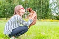 Unconditional love. Teenage girl kissing her brown toy-terrier d