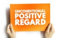 Unconditional Positive Regard - offering compassion to people even if they have done something wrong, text concept on card