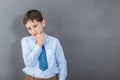 Unconfident boy student before dark background with copy-space Royalty Free Stock Photo