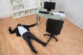 Unconscious Businessman Lying On Floor