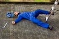 Unconscious technician fell from ladder on street Royalty Free Stock Photo