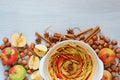 Uncooked apple tart in the baking dish decorated with fresh apples, hazelnuts, cinnamon sticks, anise. Vegetarian autumn cake