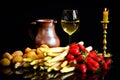 Uncooked asparagus, potatos and strawberries in front of a black background, with a glass of wine, a jar and a candle, like a stil