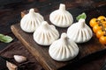 Uncooked Baozi chinese dumplings. Azian dumplings, on old dark wooden table background