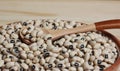 Uncooked Black Eyed Peas in Bowl on Wooden Table Royalty Free Stock Photo