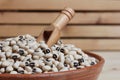 Uncooked Black Eyed Peas in Bowl on Wooden Table Royalty Free Stock Photo