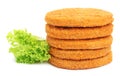 Uncooked breaded cutlets, tomato and lettuce on white background. Freshly frozen semi-finished product