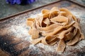 Uncooked brown pasta tagliatelle with chestnuts