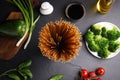 Uncooked buckwheat noodles and fresh ingredients on table, flat lay Royalty Free Stock Photo