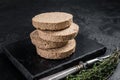 Uncooked Burgers cutlets made from plant based meat, raw vegan patties. Black background. Top view Royalty Free Stock Photo