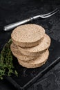 Uncooked Burgers cutlets made from plant based meat, raw vegan patties. Black background. Top view Royalty Free Stock Photo