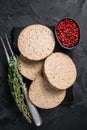 Uncooked Burgers cutlets made from plant based meat, raw vegan patties. Black background. Top view Royalty Free Stock Photo