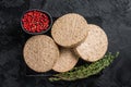 Uncooked Burgers cutlets made from plant based meat, raw vegan patties. Black background. Top view Royalty Free Stock Photo