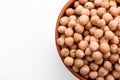 Uncooked chickpeas on a white acrylic background