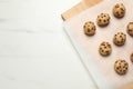 Uncooked chocolate chip cookies on white marble table, top view. Space for text Royalty Free Stock Photo